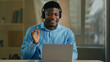© Yuliia - African American ethnic middle-aged man entrepreneur businessman employee helpline operator in headphones computer headset look at web camera speak to client video call consultation office briefing