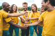 © Davide Angelini - Multiracial happy young people stacking hands outside - University students hugging in college campus - Youth community concept with guys and girls standing together supporting each other