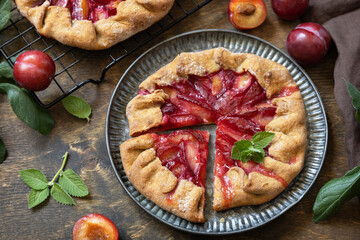 Sticker - Vegan vegetarian dessert, plums galette with almonds. Healthy homemade wholegrain fruit pie, sweet crostata on a rustic table.