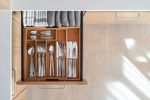 Opened Kitchen Drawer With Wooden Box For Cutlery