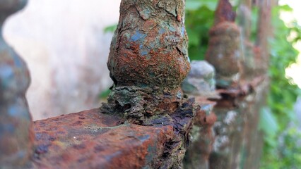 Old rusty forged fence painted with old black paint