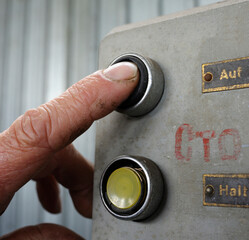 Wall Mural - Finger of worker pushing button Open on a control panel