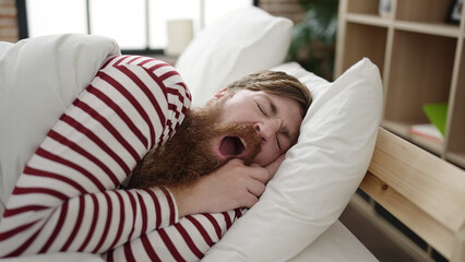 Wall Mural - Young redhead man lying on bed sleeping at bedroom