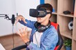 © Krakenimages.com - Young hispanic man streamer playing video game using virtual reality glasses at gaming room