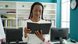 © Krakenimages.com - African american woman student reading book standing at university classroom