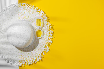 Poster - Summer flat lay white sun hat and yellow sunglasses in white plastic framed, at sunlight on bright yellow background, palm leaf shadow, copy space. Creative aesthetic Life style summer holidays