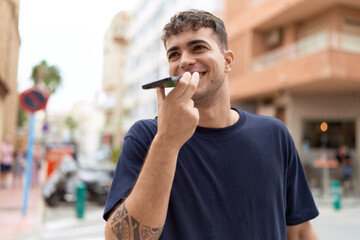 Canvas Print - Young hispanic man smiling confident talking on the smartphone at street