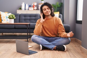 Sticker - Young latin man doing yoga exercise sitting on floor at home