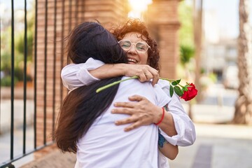 Poster - Two women mother and daughter surprise with rose at street