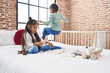 © Krakenimages.com - Adorable boy and girl drawing on notebook sitting on bed at bedroom