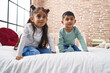 © Krakenimages.com - Adorable boy and girl smiling confident sitting on bed at bedroom