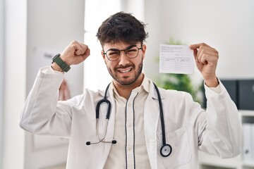 Sticker - Hispanic doctor man with beard holding covid record card annoyed and frustrated shouting with anger, yelling crazy with anger and hand raised