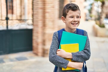 Poster - Blond child student holding books standing at street