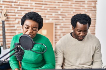 Poster - African american man and woman music group singing song playing keyboard piano at music studio