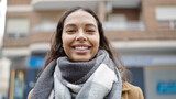 Fototapeta Sawanna - Young beautiful hispanic woman smiling confident at street