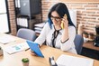 © Krakenimages.com - Young caucasian woman business worker using touchpad talking on smartphone at office
