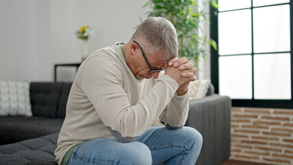 Poster - Middle age grey-haired man stressed sitting on sofa at home