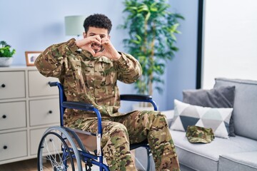 Sticker - Arab man wearing camouflage army uniform sitting on wheelchair smiling in love doing heart symbol shape with hands. romantic concept.