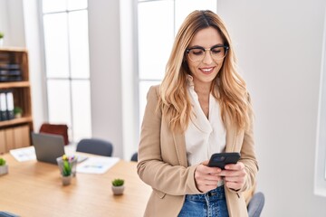 Sticker - Young blonde woman business worker smiling confident using smartphone at office