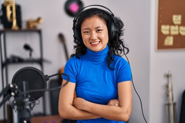 Sticker - Young chinese woman singer smiling confident with arms crossed gesrture at music studio