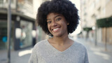 Fototapeta Uliczki - African american woman smiling confident standing at street