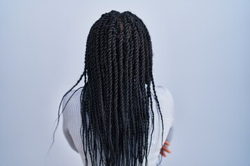 Poster - African american woman standing over blue background standing backwards looking away with crossed arms