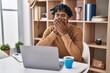© Krakenimages.com - Young african man with dreadlocks working using computer laptop shocked covering mouth with hands for mistake. secret concept.