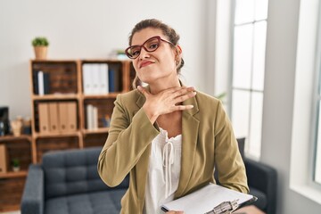 Canvas Print - Young woman working at consultation office cutting throat with hand as knife, threaten aggression with furious violence