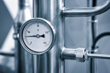 Industrial  concept. equipment of the boiler-house, - valves, tubes, pressure gauges, thermometer. Close up of manometer, pipe, flow meter, water pumps and valves of heating system in a boiler room.