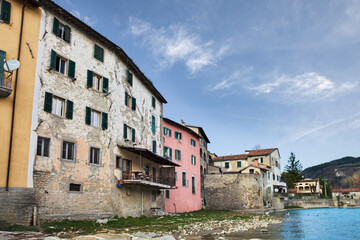 Wall Mural - Santa Sofia, Forli Cesena, Emilia Romagna, Italy: view of the old town from the river shore with the ancient houses and the Apennine mountains on background