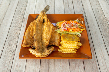 Wall Mural - A breaded sea bass split in half with a side of salad