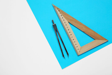 Wall Mural - Triangle ruler, paper sheet and compass on white background, flat lay