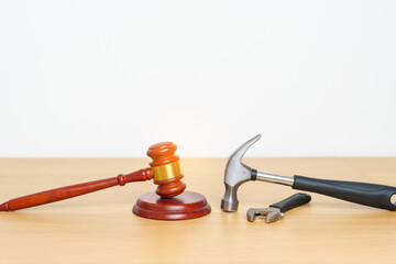 Labor law and Worker concepts. Construction hammer with gavel justice hammer on desk in courthouse.