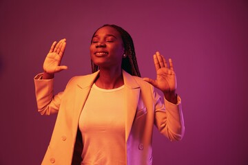 Wall Mural - Woman african american business smile dancing party in neon light, colorful pink color, bright coloring.