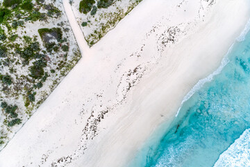 Wall Mural - Aerial view of summer seascape beautiful waves, blue sea water on sunny day. Top view from drone. Sea aerial view, amazing tropical nature background. Beautiful bright sea waves splashing on the beach