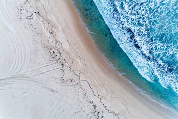 Wall Mural - Aerial view of beautiful tropical blue ocean sea waters with waves. Vibrant bright sunny day in summer wallpaper. Seascape background. Coastal wallpaper.