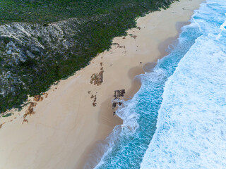 Wall Mural - Aerial top down view of beach and clear blue water. Ocean waves on the beach as a background. Beautiful natural summer vacation holidays background. Margaret River, Western Australia. Coastal seascape