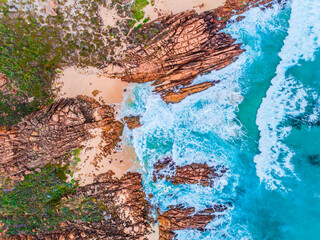 Wall Mural - Aerial top down view of beach and clear blue water. Ocean waves on the beach as a background. Beautiful natural summer vacation holidays background. Wyadup Rocks, Western Australia. Coastal seascapes