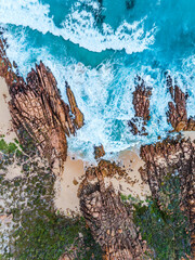 Wall Mural - Aerial top down view of beach and clear blue water. Ocean waves on the beach as a background. Beautiful natural summer vacation holidays background. Wyadup Rocks, Margaret River, Western Australia.