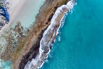 Wall Mural - Sea aerial view summer seascape beautiful waves, blue sea water reef in sunny day. Top view from drone. Amazing tropical nature background. Beautiful bright sea waves splashing on beach sand. Yanchep