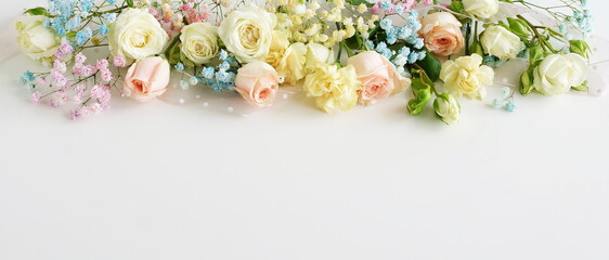 Canvas Print - Flowers background with copy space banner.Bouquet of pastel colors roses flowers frame on white backdrop. Flowers template.