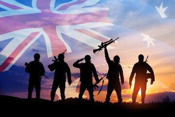 Wall Mural - Silhouettes of soldiers on background of Australia flag and the sunset or the sunrise background. Anzac Day.