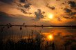 See im Abendrot - Sunset - Landscape - Beautiful Sunset scene over the lake and silhouette hills in the background - Sunrise over sea  - Colorful - Reed - Clouds - Sky - Sundown - Sun 