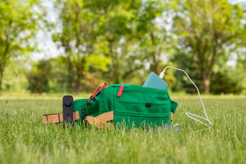 Bag with a smartphone is charged using a power bank. Portable charger in nature and travel.