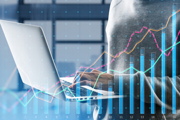 Poster - Close up of hands using laptop keyboard with growing business chart grid on blurry office interior background. Corporate growth plan and company development concept. Double exposure.