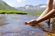 © Antonioguillem - Woman hands catching water from mountain river