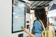 © PBXStudio - Asian woman ordering drink from touch screen electronic machine in shopping mall, electronic menu.