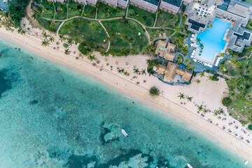 Wall Mural - Aerial view of tropical beach resort with palm trees and sea. Resort pool villas.