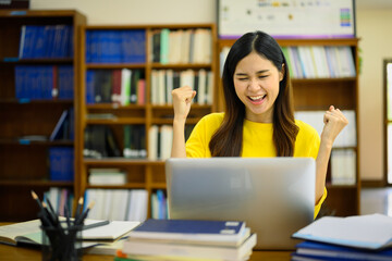 Excited happy student woman looking at laptop reading great news, passed exam, received university admission notification