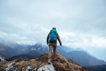 Successful woman hiker hiking at mountain top in tibet